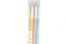 Candy colored smiling face toothbrush
